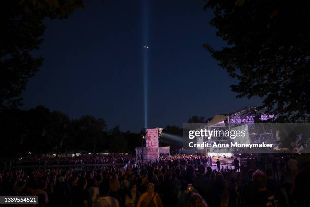 Tower of Light' tribute from the Pentagon is seen as people watch the cast of the Broadway musical ‘Come From Away' perform a free concert in front...