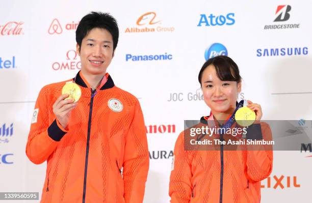 Table Tennis mixed doubles gold medalists Mima Ito and Jun Mizutani pose during the Japanese medalists press conference on day fifteen of the Tokyo...