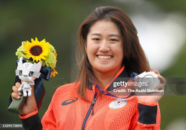 Silver medalist Mone Inami of Team Japan poses on the podium at the medal ceremony for the Women's Individual Stroke Play on day fifteen of the Tokyo...