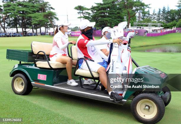 Mone Inami of Team Japan is taken to the 18th tee for the silver medal playoff first hole during the final round of the Women's Individual Stroke...