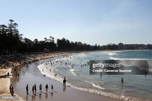 People gather at Manly Beach on September 11, 2021 in Sydney, Australia. COVID-19 restrictions are set to ease on Monday for people in NSW who are...