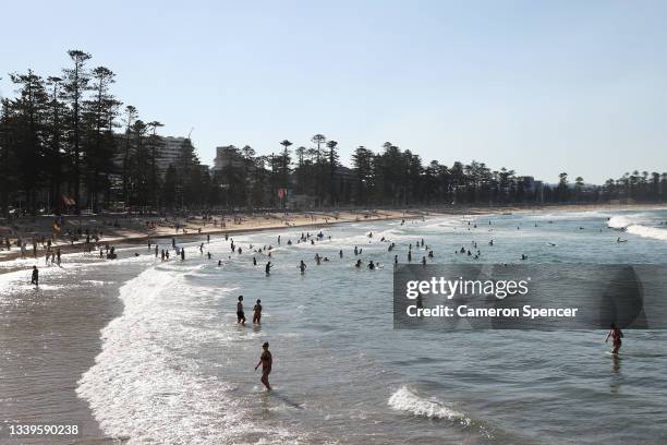 People gather at Manly Beach on September 11, 2021 in Sydney, Australia. COVID-19 restrictions are set to ease on Monday for people in NSW who are...