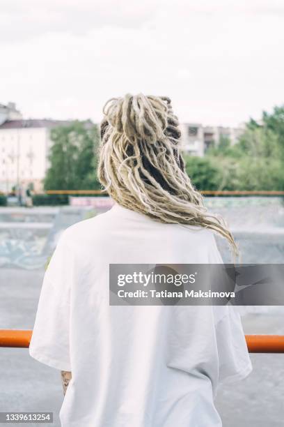 back view of young woman with dreadlocks. - rastazopf stock-fotos und bilder