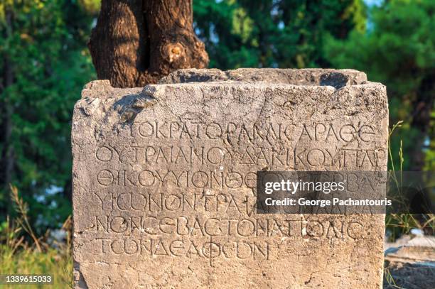 inscription in ancient greek at the delphi archaeological site, greece - delphi stock pictures, royalty-free photos & images