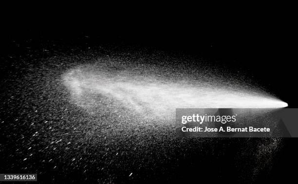 drops of a jet of water under pressure on a black background. - water spraying stock pictures, royalty-free photos & images