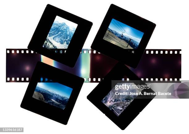 close-up of photographic slides and color negative 35mm film stripes on a white background. - 35 mm film stock-fotos und bilder