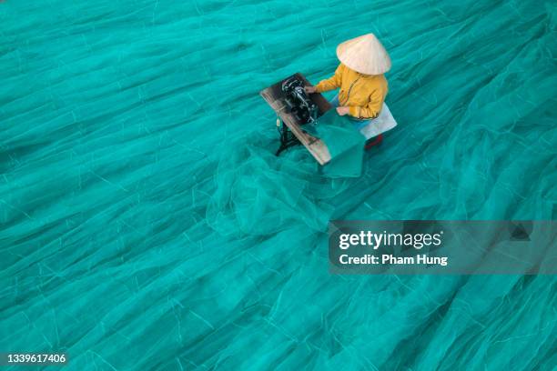 woman knitting net - asian style conical hat stock pictures, royalty-free photos & images