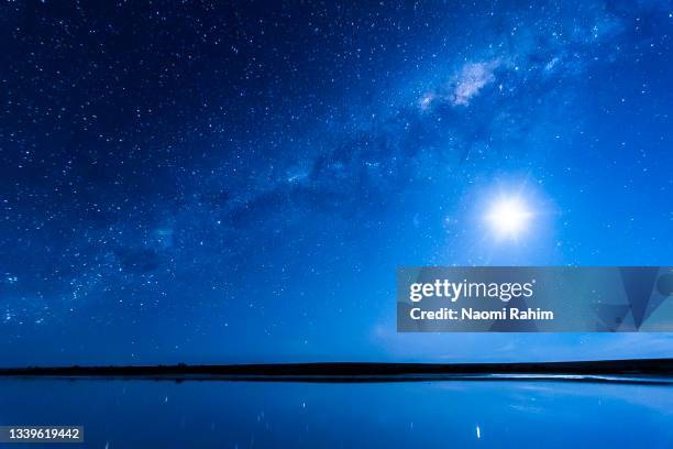 majestic landscape milky way and full moon shining in a blue starry night sky over lake tyrrell - melbourne star stock pictures, royalty-free photos & images