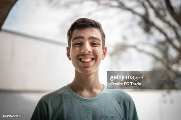 portrait of a teenager boy at home - autism stock pictures, royalty-free photos & images