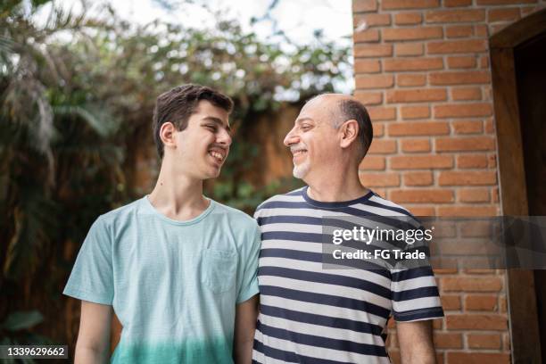 father and son looking at each other at home - autistic adult imagens e fotografias de stock