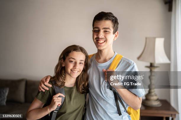 retrato de um adolescente irmãos com mochila em casa - autism - fotografias e filmes do acervo