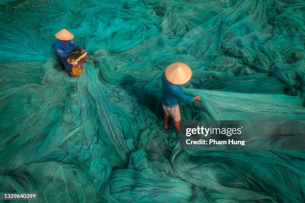 two men is fixing fishing net - nha trang bildbanksfoton och bilder