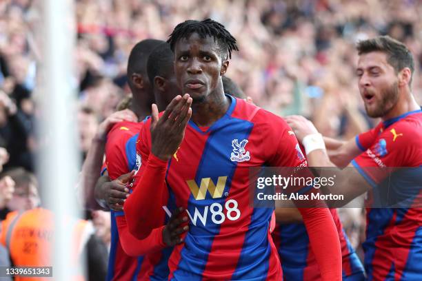 Wilfried Zaha of Crystal Palace celebrates after scoring their side's first goal during the Premier League match between Crystal Palace and Tottenham...