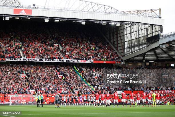Players, officials and fans take part in a minutes silence in remembrance of the victims of the 9/11 terror attacks prior to the Premier League match...