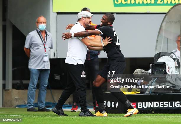 Anthony Modeste of 1.FC Koeln celebrates after scoring their side's first goal with Steffen Baumgart, Head Coach of 1.FC Koeln during the Bundesliga...