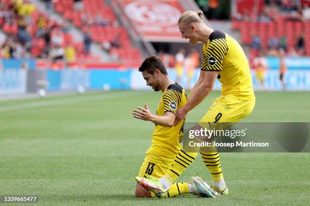 Raphael Guerreiro and Erling Haaland of Dortmund celebrate their teams third goal during the Bundesliga match between Bayer 04 Leverkusen and...