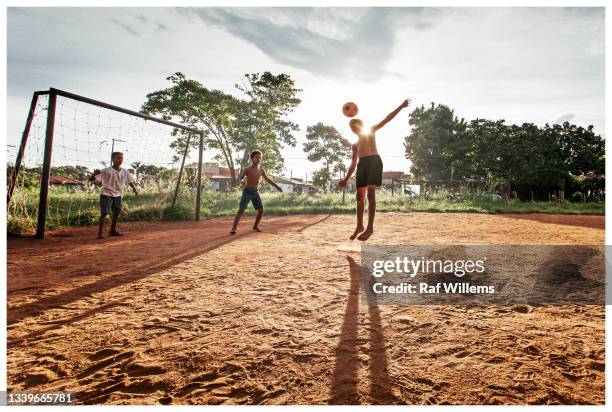 boys playing soccer, brazil - poor kids playing soccer stock-fotos und bilder