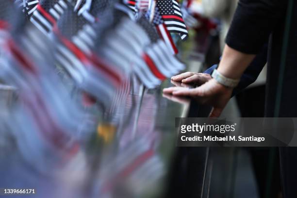 People place their hands on the memorial during the annual 9/11 Commemoration Ceremony at the National 9/11 Memorial and Museum on September 11, 2021...