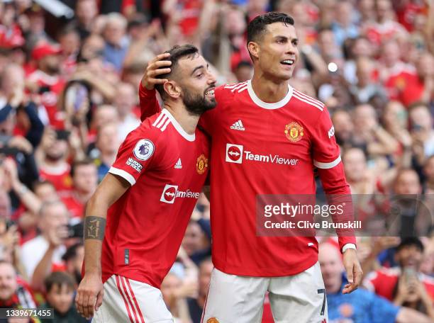 Bruno Fernandes of Manchester United celebrates with Cristiano Ronaldo after scoring their side's third goal during the Premier League match between...