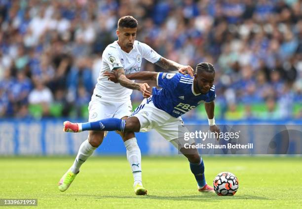 Ademola Lookman of Leicester City battles for possession with Joao Cancelo of Manchester City during the Premier League match between Leicester City...