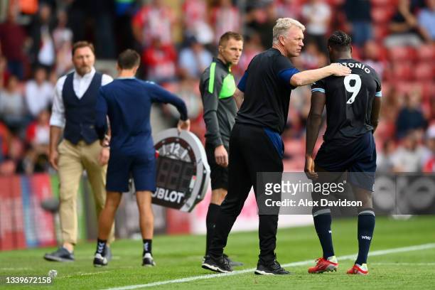 Michail Antonio of West Ham United is consoled by David Moyes, Manager of West Ham United after he is shown a red card during the Premier League...