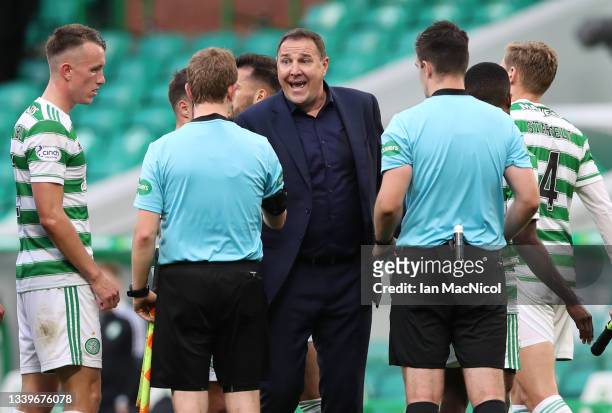 Ross County manager Malky MacKay talks to match official as full time during the Cinch Scottish Premiership match between Celtic FC and Ross County...