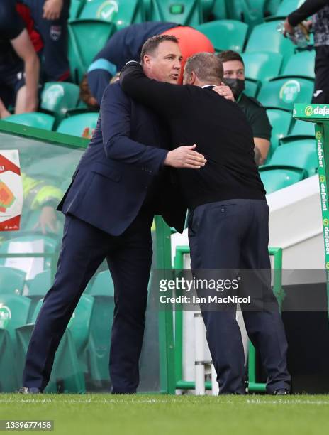 Ross County manager Malky MacKay embraces Celtic manager Ange Postecoglou during the Cinch Scottish Premiership match between Celtic FC and Ross...