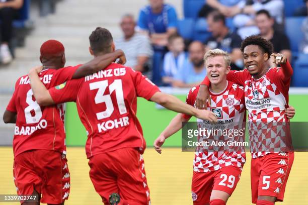 Jonathan Burkardt of Mainz celebrates his team's first goal with teammates Leandro Barreiro Martins, Jean-Paul Boetius and Dominik Kohr during the...