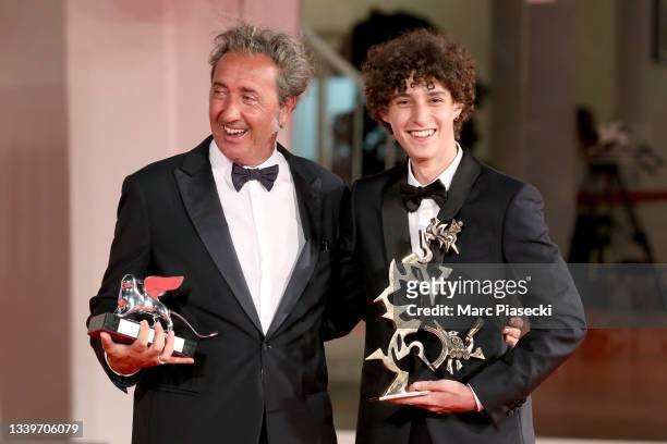 Director Paolo Sorrentino and Filippo Scotti pose with the Silver Lion Grand Jury Prize and the Marcello Mastroianni Award for Best New Young Actor...