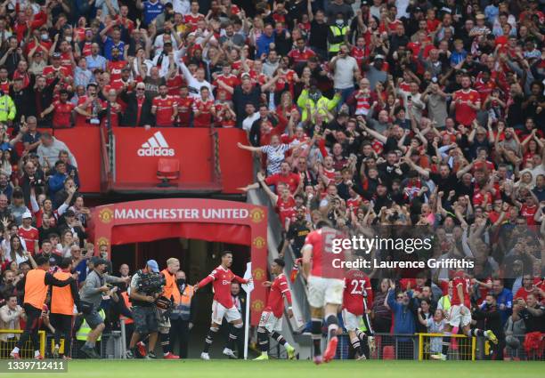 Cristiano Ronaldo of Manchester United celebrates in front of the Stretford End after scoring his second goal during the Premier League match between...