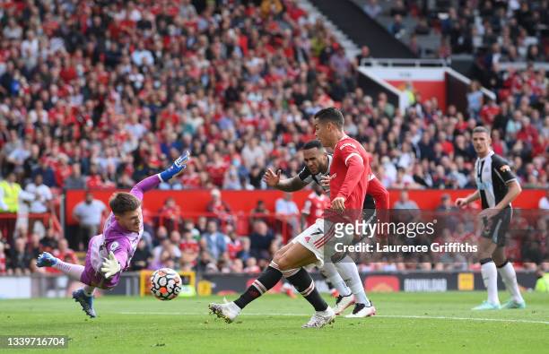 Cristiano Ronaldo of Manchester United scores his sides first goal past Freddie Woodman of Newcastle United during the Premier League match between...