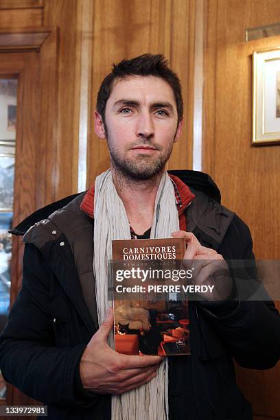 French novelist Erwann Créac'h shows his novel "Carnivores Domestiques" after being awarded with the 30 Millions d’amis literary prize on November...