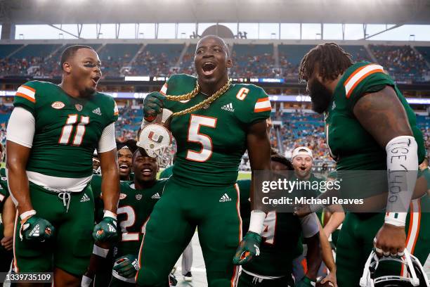 Amari Carter of the Miami Hurricanes celebrates with the Turnover Chain after intercepting a pass from Chase Brice of the Appalachian State...