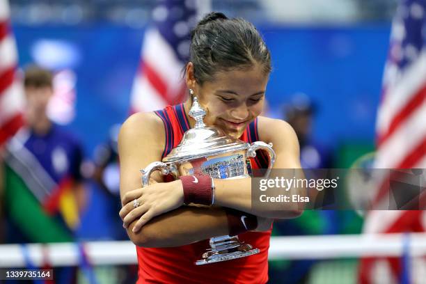 Emma Raducanu of Great Britain celebrates with the championship trophy after defeating Leylah Annie Fernandez of Canada during their Women's Singles...