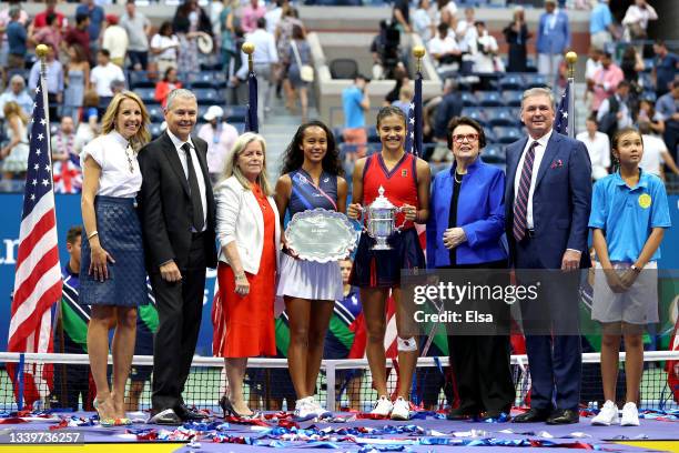 Leylah Annie Fernandez of Canada holds the runner-up trophy as Emma Raducanu of Great Britain celebrates with the championship trophy alongside...