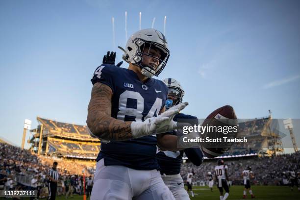 Theo Johnson of the Penn State Nittany Lions celebrates after scoring a touchdown against the Ball State Cardinals during the second half at Beaver...