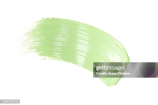 smooth cosmetic smear of pastel green paint isolated on white background. concept of home repair and herbal cosmetic. flat lay style - green room stockfoto's en -beelden