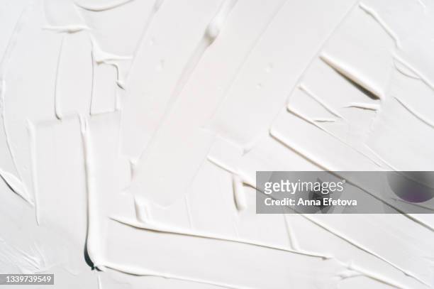background made with textured smears of white cream. body lotion for perfect skin. copy space for your design. macrophotography in flat lay style - alcorza fotografías e imágenes de stock