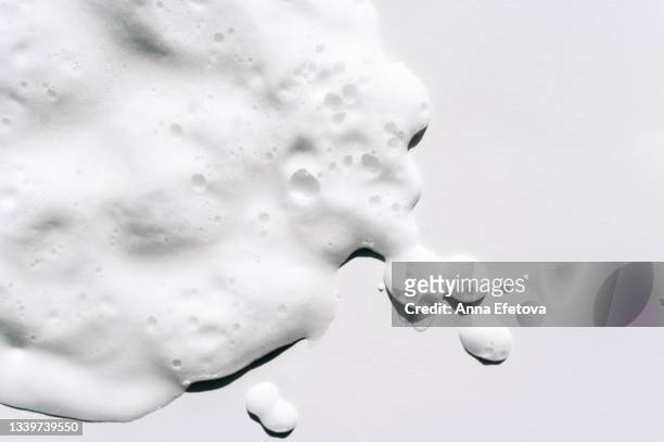 texture of white foam on white background. facial cleanser for perfect skin. copy space for your design. macrophotography in flat lay style - soap bildbanksfoton och bilder