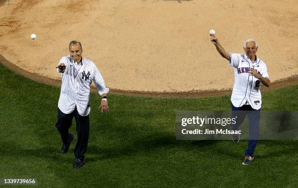 Former New York Yankees manager Joe Torre and former New York Mets manager Bobby Valentine throw out the ceremonial first pitches during ceremonies...