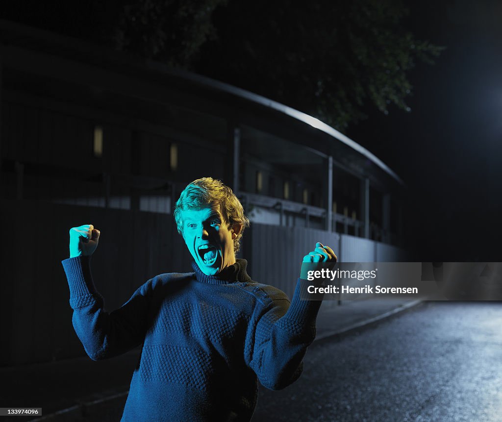 Young man cshouting in the street