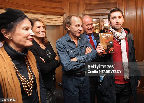 French novelist Erwann Créac'h shows his novel "Carnivores Domestiques" after being awarded with the 30 Millions d’amis literary prize on November...