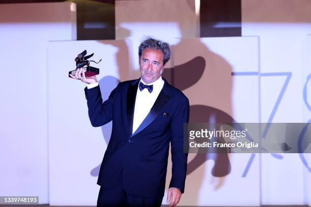 Director Paolo Sorrentino poses with the Silver Lion Grand Jury Prize for "The Hand Of God" at the awards winner photocall during the 78th Venice...