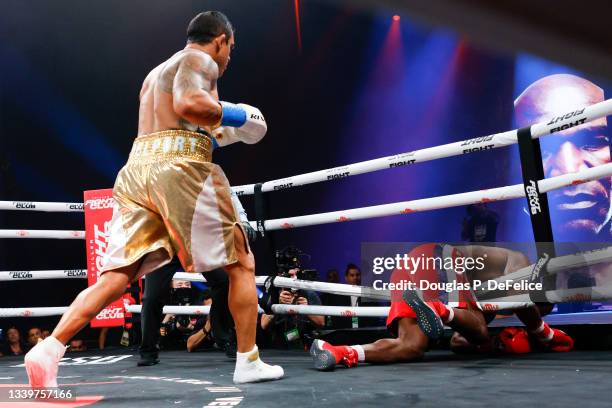 Vitor Belfort knocks down Evander Holyfield during the first round of the fight during Evander Holyfield vs. Vitor Belfort presented by Triller at...
