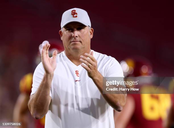 Head coach of the USC Trojans Clay Helton, cheers on his team during warm up before the game against the Stanford Cardinal at Los Angeles Memorial...