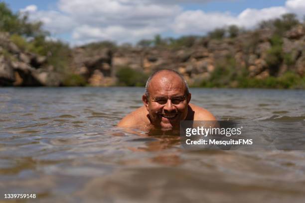 mature man bathing river - river bathing imagens e fotografias de stock