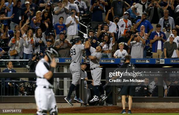 Aaron Judge of the New York Yankees celebrates with teammate Rougned Odor after an eighth inning two RBI home run against the New York Mets at Citi...