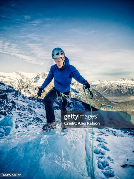 mountain climber climbs a tall icefall above joffre lake near pemberton, bc - icefall stock pictures, royalty-free photos & images