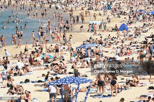 Sunbakers gather on Coogee Beach on September 12, 2021 in Sydney, Australia. COVID-19 restrictions are set to ease on Monday for people in NSW who...