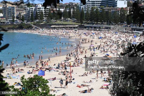 Sunbakers gather on Coogee Beach on September 12, 2021 in Sydney, Australia. COVID-19 restrictions are set to ease on Monday for people in NSW who...